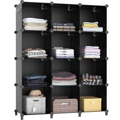 an open shelving unit with clothes and boxes on the bottom shelf, in front of a white background