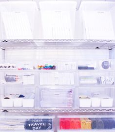 an organized closet with plastic drawers and bins filled with crafting supplies on the shelves