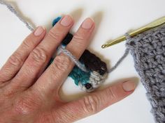 someone is crocheting something with their fingers and the yarn has been stitched together