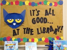 there is a bulletin board with pete the cat on it and some books in front of it