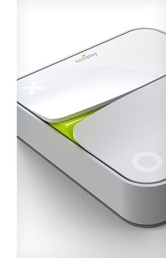 a white and green computer mouse sitting on top of a desk