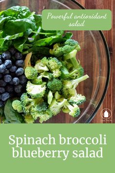 spinach broccoli blueberry salad in a glass bowl