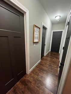 an empty hallway with two doors and a sign hanging on the wall above it that says feet first home