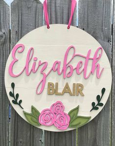 a sign that says elizabeth blair with pink flowers and leaves on the front