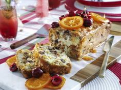 there is a piece of cake on the plate with orange slices and cherries around it