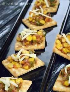 several square pieces of food with toppings on them sitting on top of a table