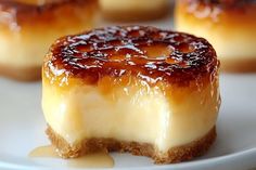 small cheesecakes on a white plate with caramel sauce