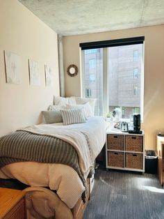 a bed sitting next to a window in a bedroom