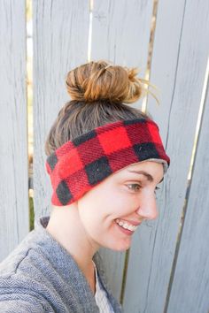 a woman wearing a red and black plaid headband