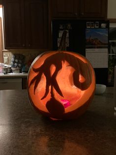 a carved pumpkin sitting on top of a kitchen counter