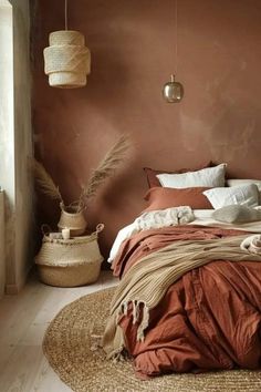 a bed in a bedroom with brown walls and rugs on the floor next to it