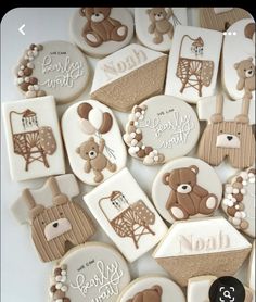 decorated cookies with teddy bears and other baby related items are arranged on a white surface