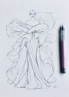 a drawing of a woman in a long dress with her hands on her hips, next to a ballpoint pen