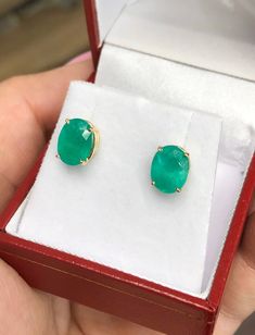 Featured here is a stunning set of oval Colombian emerald studs in fine 14K yellow gold. Displayed are medium-green emeralds with very good transparency, accented by a simple four-prong solid gold mount, allowing for the emerald to be shown in full view. The earth mined, green Colombian emeralds have a desirable lush green color with excellent qualities. These earrings are ideal for everyday use and are the perfect accessory to any outfit. Total Carat Weight: 3.20-carats Setting Style: Four Pron Oval Emerald Earrings For May Birthstone, Formal Oval Cabochon Emerald Jewelry, Fine Jewelry Oval Emerald Earrings, Oval Emerald Necklace In Yellow Gold, Hallmarked, Oval Emerald Gemstone Earrings, Emerald Earrings Studs, Colombian Emeralds, Emerald Earrings, Emerald Jewelry