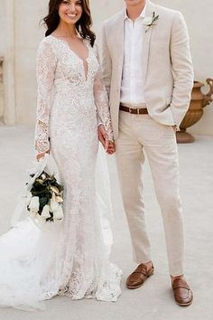 a bride and groom standing in front of a building