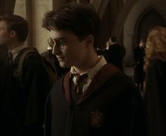 harry potter is standing in front of other people