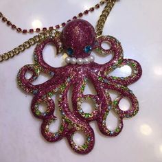 A Glittering Pink Octopus Shows Off Her Pearls And Jewel-Encrusted Arms On A Girly Statement Necklace. Lobster Clasp Closure. Approx. Length: 20" With 3" Extender. Approx. Pendant Diameter: 3". Gold Plate/Glass/Glass Pearl. By Betsey Johnson; Imported. Extremely Rare And Adorable Purple Whimsical Necklace For Party, Whimsical Purple Necklace For Party, Glamorous Pink Necklace For Party, Unique Pink Necklace For Party, Pink Bling Necklace For Gift, Sparkling Pink Jewelry For Party, Pink Rhinestone Party Necklaces, Gold Lipstick, Betsey Johnson Sunglasses