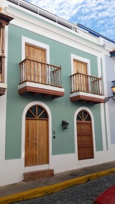 an old building with balconies and wooden doors