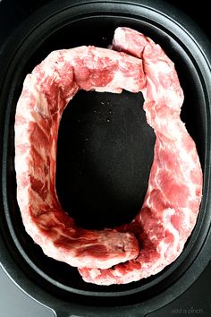 raw meat in an air fryer basket ready to be cooked