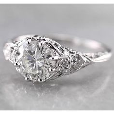 an antique style engagement ring with diamonds