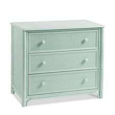 a green dresser with three drawers and two knobs on the top, in front of a white background