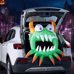 a car with an open trunk decorated like a monster