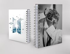 two spiral notebooks, one with an image of a man holding a camera