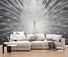 a living room with a large white peacock wall mural