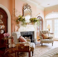 a living room filled with furniture and a fire place in the middle of a room