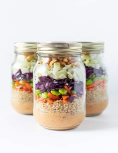 three mason jars filled with salad in a jar and the text, peanut crunch salad in a jar vegan gluten - free & oil - free will keep up 5 days at the fridge