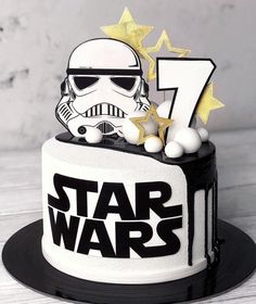 a star wars themed birthday cake with the number seven on it and a storm trooper figurine