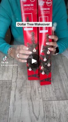 a woman holding up two boxes with christmas decorations on them and the words dollar tree makeover