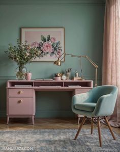 a pink desk and chair in front of a blue wall with flowers on the top