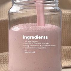 a glass jar filled with pink liquid on top of a table