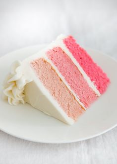 a piece of cake with pink and white frosting