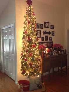 a decorated christmas tree in the corner of a room