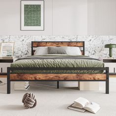 a bed sitting in a bedroom next to a book on top of a wooden table