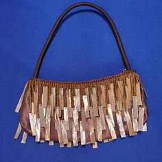 This purse is a beautiful bronze color. A true work of art This would look wonderful with a black or cream colored evening dress. Very unique, one of a kind purse. The inside is lined with one pocket. The real seashells are polished to bring out the amazing colors. If your looking for something different and absolutely beautiful, this is it We have this purse available in three colors, look at the pictures. We also carry different styles. 8" handle 9" x 4" Handmade Brown Evening Bag For Party, Handmade Brown Shoulder Bag For Evening, Evening Brown Handmade Shoulder Bag, Evening Handmade Brown Shoulder Bag, Elegant Handmade Brown Shoulder Bag, Elegant Handmade Brown Evening Bag, Elegant Brown Shoulder Bag For Party, Evening Purse, Three Color