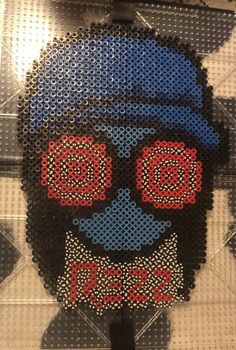 a skull made out of plastic beads with a blue hat