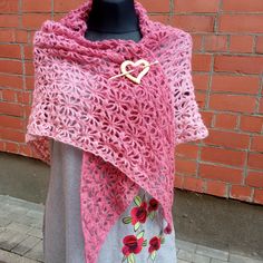 This beautiful women's scarf is hand crocheted from Alize angora in pink. Photo attached. The shawl is crocheted with an original openwork pattern that any woman will like. The top of the shawl is a slightly darker pink than the bottom. Shawl length 200 cm. Shawl width 75 cm. The shawl is accompanied by a handmade wooden brooch in the shape of a heart. The brooch allows you to secure the scarf in any way convenient for you. The shawl will keep you warm and add charm. The shawl is hand knitted wi One Size Pink Shawl For Winter, Pink One Size Shawl For Winter, Pink One-size Winter Shawl, Winter Gift Shawl, Bohemian Hand Knitted Shawl As Gift, Hand Knitted Shawl Scarf, Hand Knitted Shawl Wrap, Pink One Size Shawl, Handmade Yarn Shawl For Winter