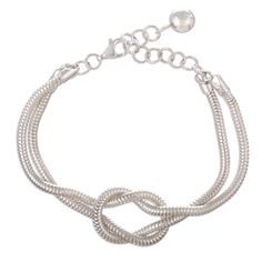 Snake chains are beautifully twisted to form a classic Infinity knot for this wristband bracelet that can be worn by both women and men. The unisex bracelet is crafted from polished sterling silver and designed by artisan Adriana de Gadea in Peru. Elegant Adjustable Chain Bracelet With Sterling Silver Clasp, Adjustable Twisted Modern Jewelry, Modern Adjustable Infinity Jewelry, Modern Adjustable Twisted Jewelry, Silver Flexible Bracelets, Elegant Metal Bracelets With Flexible Fit, Adjustable Infinity Jewelry With A Modern Twist, Adjustable Sterling Silver Clasp Chain Bracelet, Adjustable Silver Chain Braided Bracelet As Gift