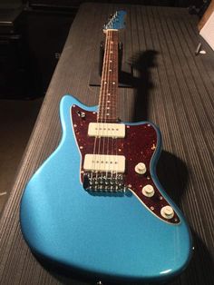 a blue guitar sitting on top of a table