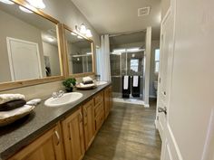 a bathroom with two sinks and mirrors in it