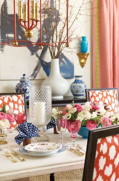 a dining room table set with place settings