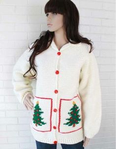 a mannequin wearing a white knitted christmas cardigan with trees on it