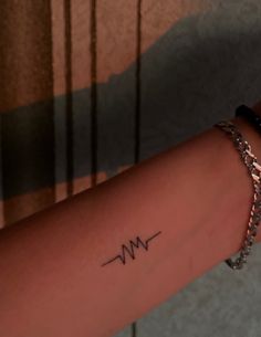 a woman's arm with the word m and w on it in cursive writing