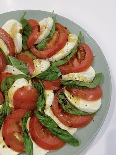 tomatoes, mozzarella and spinach on a plate