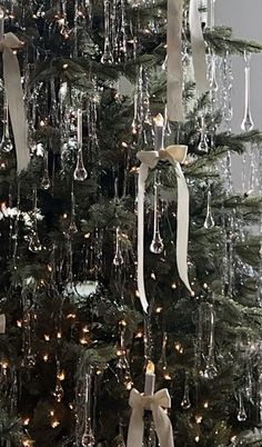 a decorated christmas tree with wine glasses hanging from it