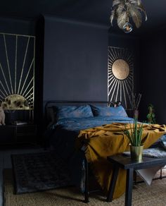 a bed room with a neatly made bed next to a night stand and side tables