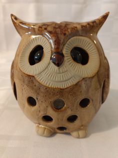 an owl figurine sitting on top of a table